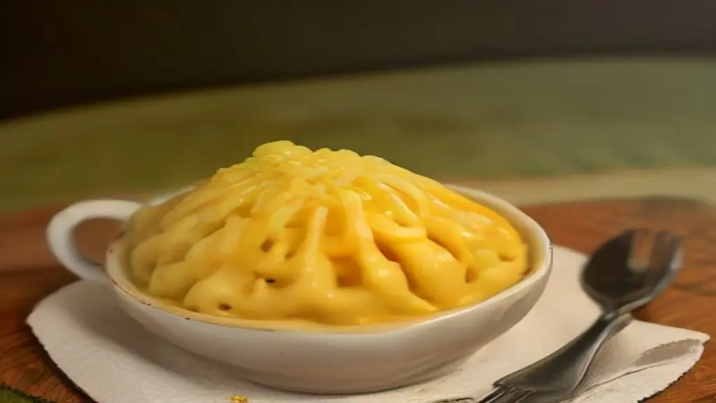 A close-up view of a kitchen skillet showing the preparation step of combining seared pieces of meat with cooked pasta for a recipe featuring Garlic Butter Steak Bites with Cheese Tortellini in Alfredo Sauce.